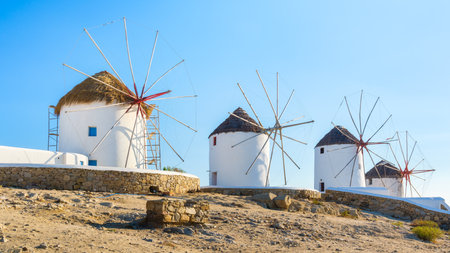 Mykonos, Greece. Traditional windmills. The symbol of Mykonos at the day time. Landscape with traditional windmils. Photo for travel and vacation.の写真素材
