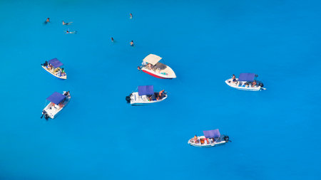A boat in the lagoon. View of the sea bay and a lone boat from a drone. Blue sea water. Vacation and travel. Summer landscape from the air.の写真素材