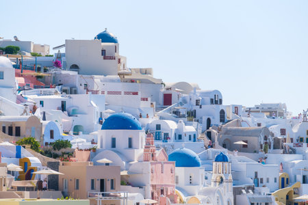 Oia village, Santorini, Greece. Architectural background. View of traditional houses in Santorini. Small narrow streets and rooftops of houses and hotels. Travel and vacation photography.の写真素材