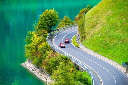 Lungern, canton of Obwalden, Switzerland. The road by the shore of the lake. A lake in a mountain valley. A popular place to travel.の写真素材