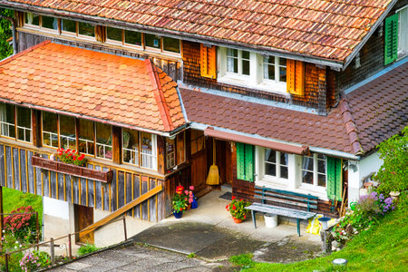 House and yard design in the old style. The facade of an apartment building. Pots of flowers.の写真素材