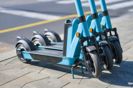 Electric scooter on the street. Eco-friendly fashion or transport. Transport for rent to move around the city. Modern technology.の写真素材
