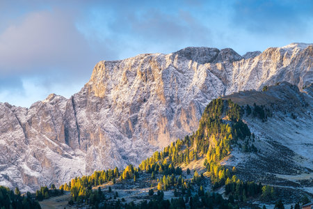 High rocks during sunset. Dolomite Alps, Italy. Mountains and cloudy skies. View of mountains and cliffs. Natural mountain scenery. Photography as a background for travel.の写真素材