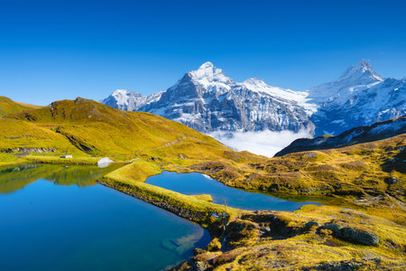 Grindelwald, Switzerland. High mountains and reflection on the surface of the lake. Mountain valley with lake. Landscape in the highlands in the summertime.の写真素材