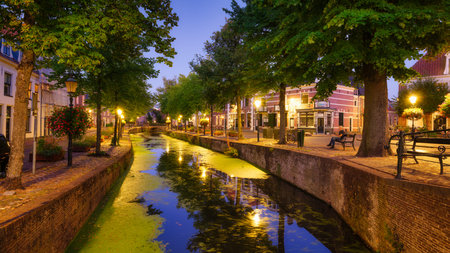 Architecture in the Netherlands. Modern and old buildings. Canals and bridges. Architectural landscape. Evening lighting in the city. Postcard view.の写真素材
