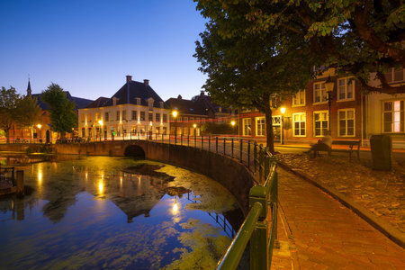 Architecture in the Netherlands. Modern and old buildings. Canals and bridges. Architectural landscape. Evening lighting in the city. Postcard view.の写真素材