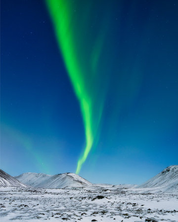 Aurora Borealis in Iceland. Northern Lights over the mountains. A winter night landscape with bright lights in the sky. Landscape in the north in winter time. A popular place to travel.の写真素材