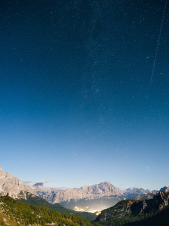 High mountains and stars. Dolomite Alps, Italy. Landscape in the highlands at the night. Night wallpaper. Photo in high resolution.の写真素材