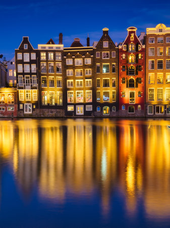 Damrak, Amsterdam, Netherlands. View of houses during sunset. The famous Dutch canals. A cityscape in the evening. Travel photography.の写真素材