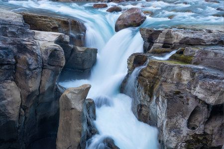 Waterfall and rocks. Long exposure photography. Fast river and waterfall. Natural background and wallpaper. Blurry fast water.の写真素材