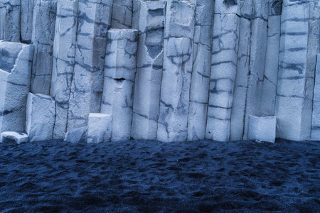 Basalt stones as a background. Reynisfjara Beach, Iceland. Sharp rocks. Photography for design. Textures in nature.の写真素材