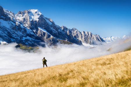 Tourist with a backpack in the mountains. Mountain hiking in the high mountains. Travel and adventure. Active life. Landscape in the summertime. Photo with high resolution.の写真素材