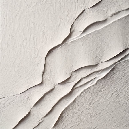 white wall with cracks and peeling plaster, abstract background photo textureの素材