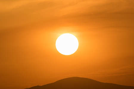 Close up of the sun against the mountains.の写真素材
