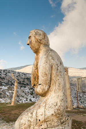 Athens, Greece 02 January 2016. The thinking man wood carving at the park of lost souls Parko Psychon at Parnitha mountain.のeditorial素材