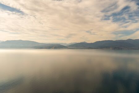 Dramatic landscape of the mountains, the sea and the fog at Nafplio in Greece. View from Palamidi castle.の写真素材