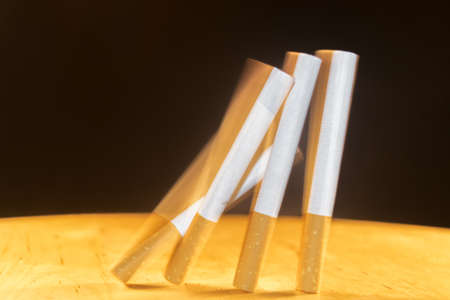 Domino of cigarettes falling with a rear curtain technique.の写真素材