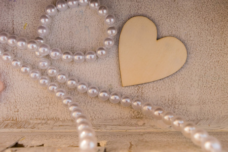 One wooden heart and a necklace as decoration at a Greek  baptism.