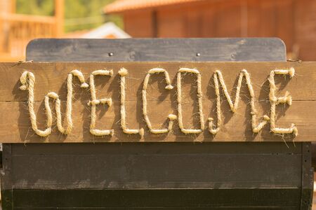 Welcome message made of ropes outside of a saloon.の写真素材