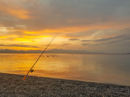 Fishing rod against the sunset. A summer scenery.の写真素材