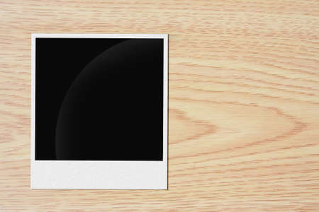 blank vintage paper and photo frame on wooden background 