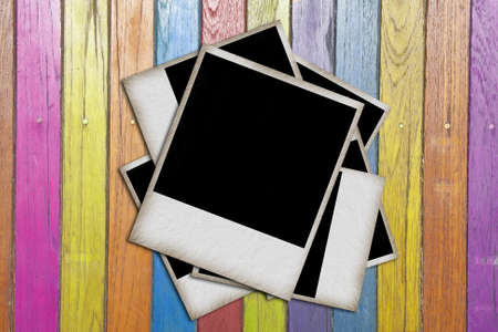 blank vintage paper and photo frame on wooden background