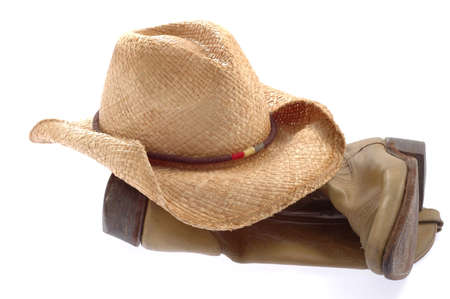 Worn cowbot hat and boots on a white background.の写真素材