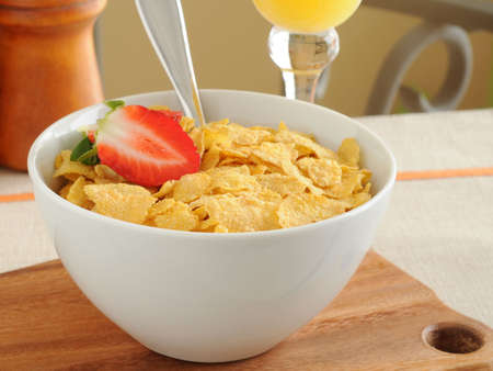 Bowl of crunch corn flakes with strawberries.
