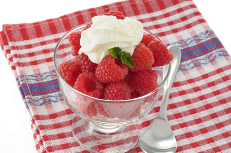 Freshly picked raspberries served with whipped cream.