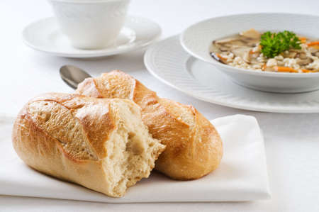 Fresh baked french baguette accompanying hot soup.の写真素材