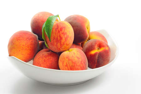 Bowl of fresh picked ripe peaches.の写真素材