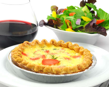 Smoked salmon and herb quiche with a salad.の写真素材