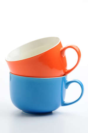 Two colorful ceramic mugs stacked.の写真素材
