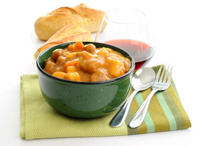 Homemade beef stew with crusty bread and wine.の写真素材