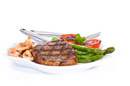 Grilled eye of round steak served with vegetables.の写真素材