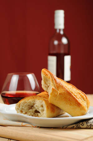 Fresh french bread served with red wine.の写真素材