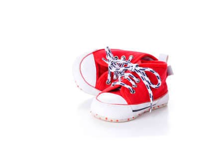 Pair of baby sized running shoes on a white background.の写真素材