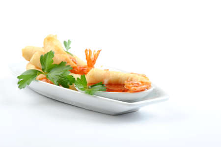 delicious deep fried shrimp with spicy orange dipping sauce.の写真素材
