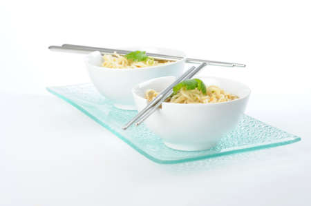 Bowls of oriental rice noodles with chopsticks.の写真素材