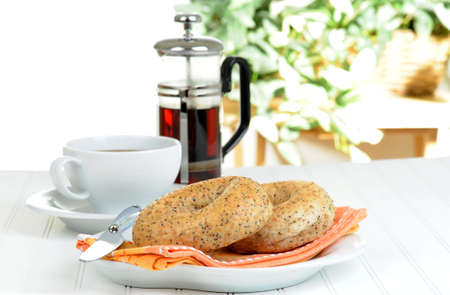 Two flax bagels on a plate served with coffee.の写真素材