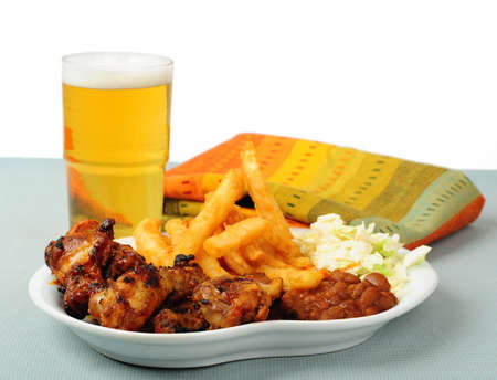 Plate of delicious barbecued chicken wings with beer.の写真素材