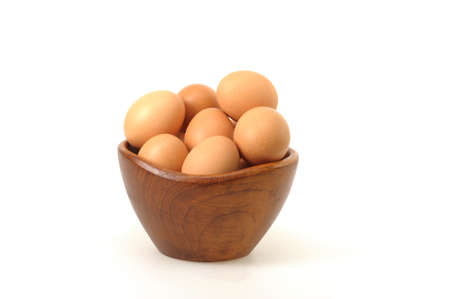 Farm fresh eggs in a bowl on a white background.