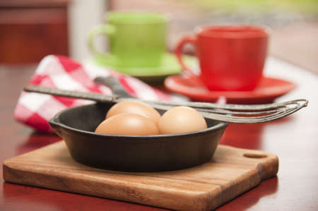 Three whole eggs in a skillet to be prepared for breakfast.の写真素材