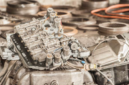 Pile of dirty used automobile parts for repair or recycling.