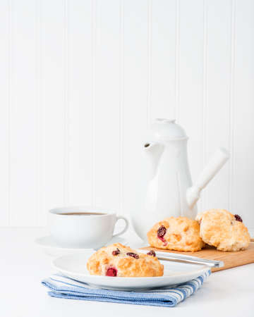 Fresh made cranberry scones served with hot tea.の写真素材