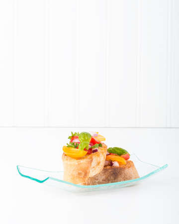 Colorful bruschetta on a glass plate.  Suitable for a wide range of food service applications.の写真素材