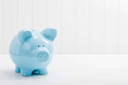 Blue porcelain piggybank with ample copy space.の写真素材