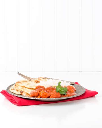 Chicken with spicy Indian butter sauce with rice and nan bread.の写真素材