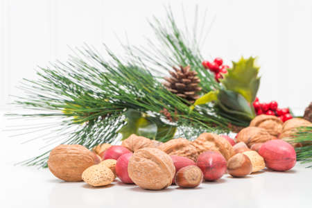 Variety of mixed nuts in the shell with a festive background.の写真素材