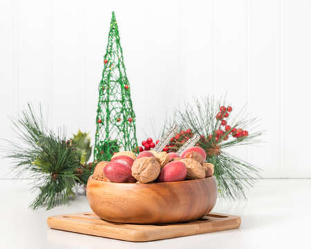 Bowl of whole mixed nuts with a seasonal background.の写真素材